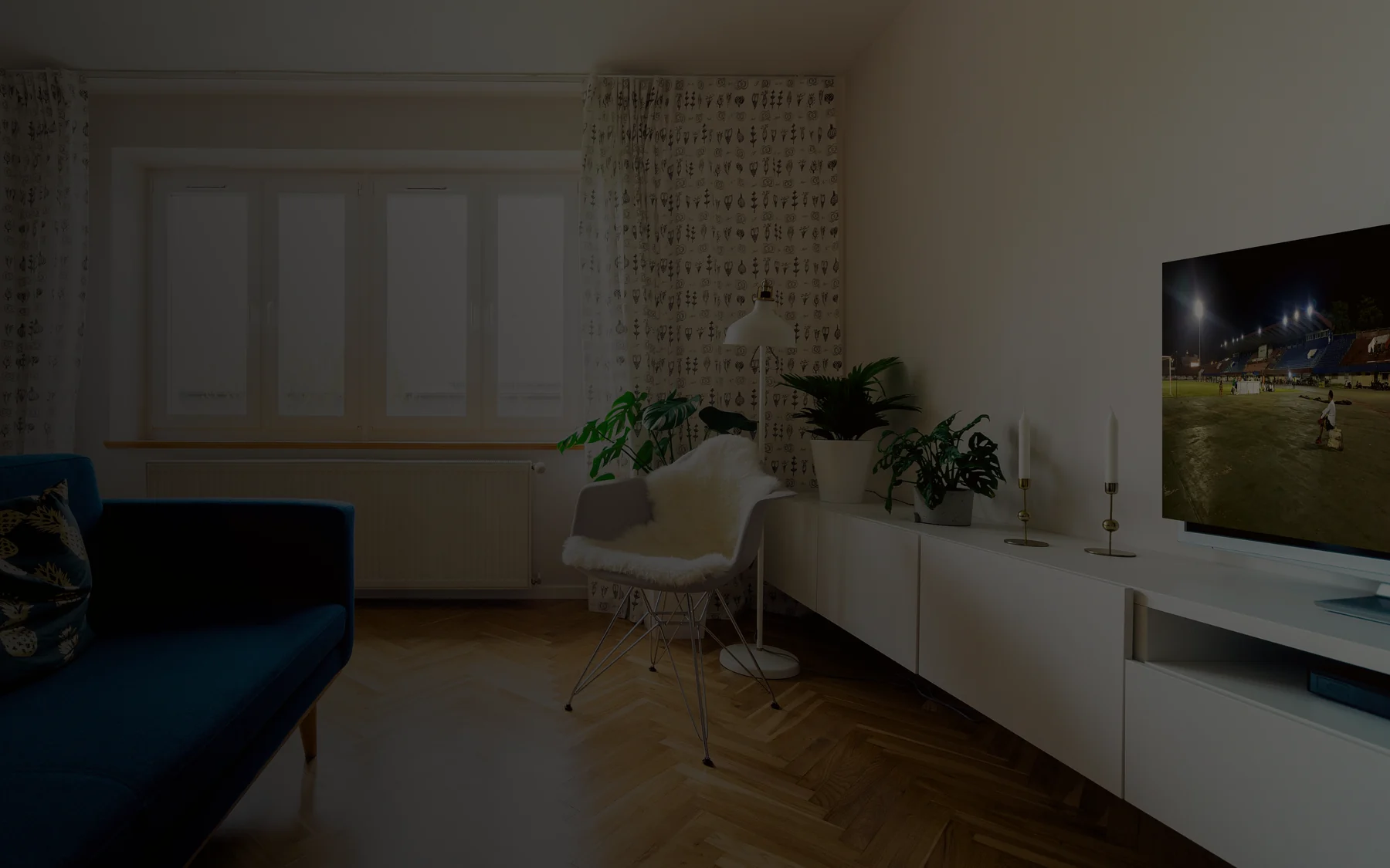 Modern living room with football playing on television